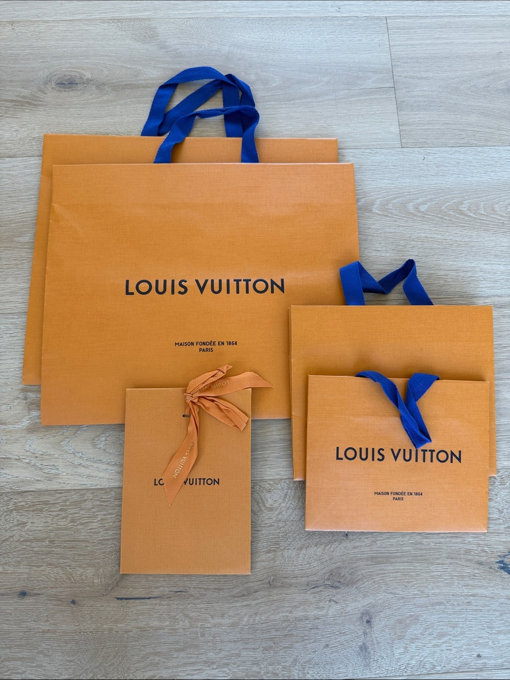 5 Louis Vuitton Orange Shopping Bags with Blue Ribbon Handles